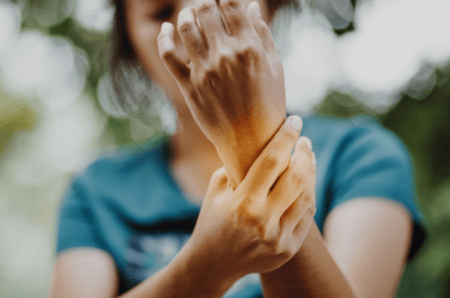 Photo of woman with rheumatoid arthritis holding her wrist