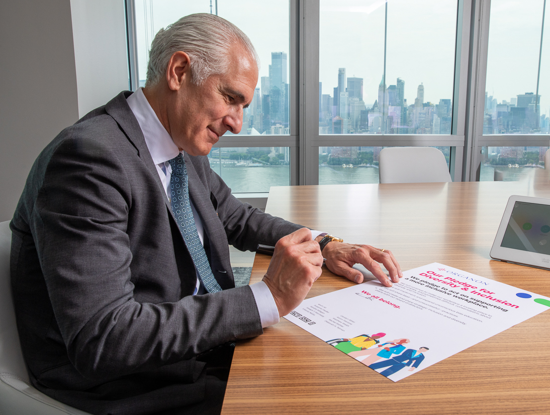 Image of Organon CEO, Kevin Ali signing diversity pledge