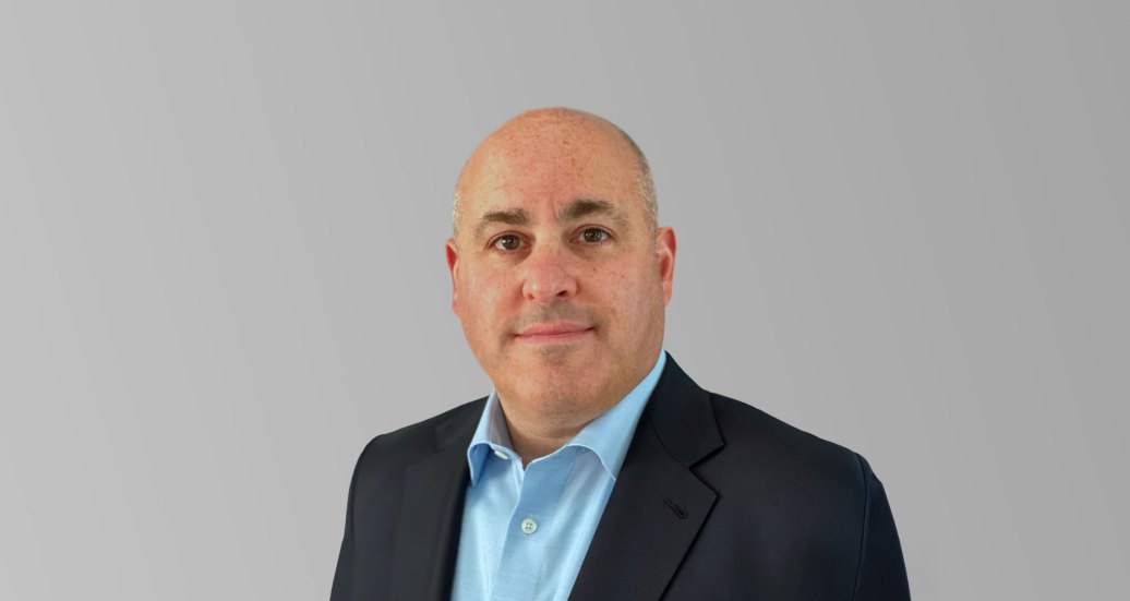 Headshot of Mike Pergine with wide background