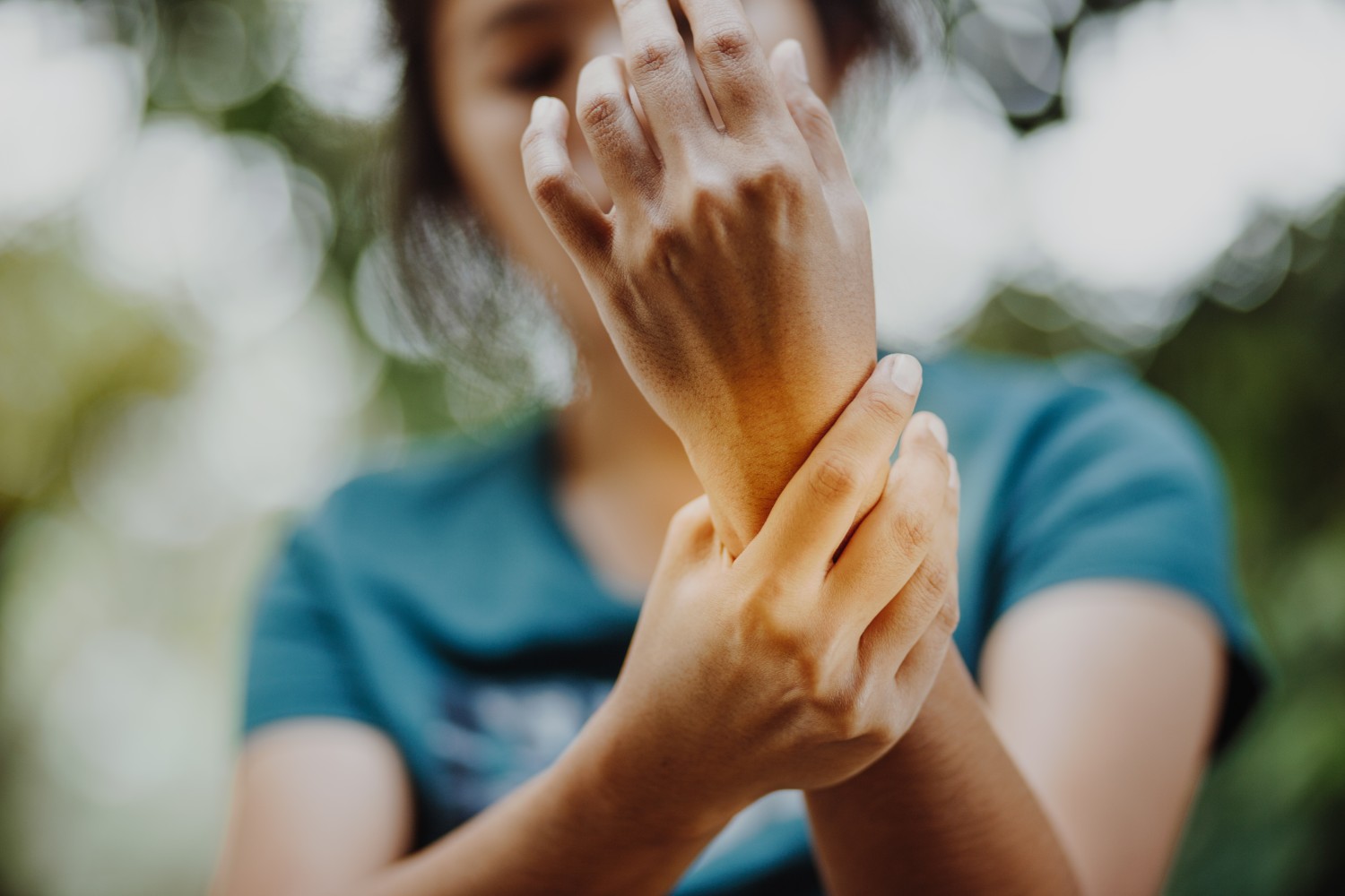 Photograph of woman with rheumatoid arthritis holding wrist