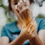 Photograph of woman with rheumatoid arthritis holding wrist